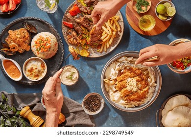 Middle Eastern or Arabic cuisine with a variety of mezze on a rustic concrete backdrop Food that is Halal. Cuisine from Lebanon, Turkey, and Egypt, with mixed veggies and a gorgeous table top view
