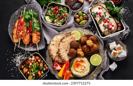 Middle eastern or Arabic different dishes on black background. Tasty traditional food concept. Top pview