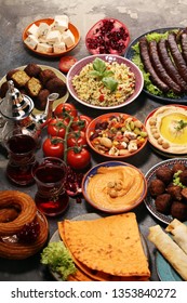 Middle eastern or arabic dishes and assorted meze, concrete rustic background. Falafel. Turkish Dessert Baklava with pistachio. Middle eastern or arabic dishes and assorted