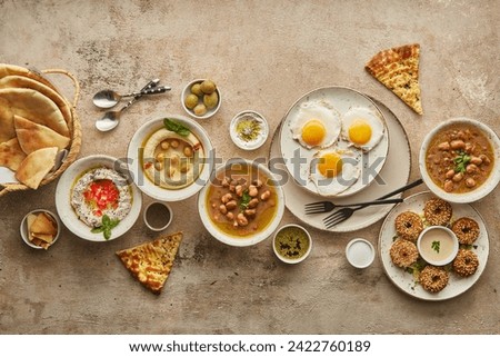 Middle eastern or arabic dishes and assorted meze, dessert, sandwiches Meat kebab, falafel, baba ghanoush, muhammara, pizza, hummus, sambusak, rice, tahini, kibbeh, pita. Halal food. Lebanese cuisine