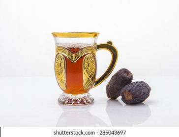 Middle Eastern Beverage And Refreshment. Cup Of Black Arabic Tea And Date Fruits. 