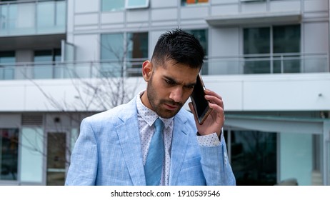 Middle Eastern Businessman Making A Phone Call With A Serious Look