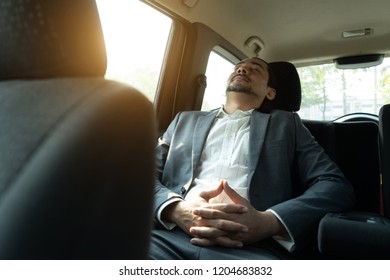 Middle Eastern Businessman Riding A Car Sleeping