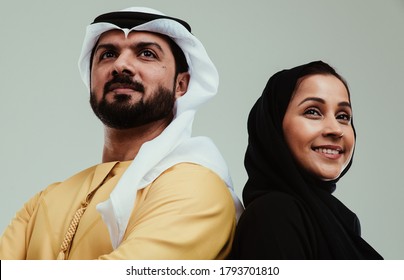 Middle eastern couple studio portraits. People from united arab emirates with traditional outfits