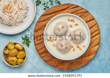 Middle Eastern dish Kibbeh bi Laban . Ground meat with bulgur wheat and yogurt sauce . Top view                    