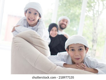 Middle eastern family at home on couch - Shutterstock ID 218977135