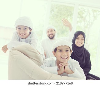 Middle Eastern Family At Home On Couch