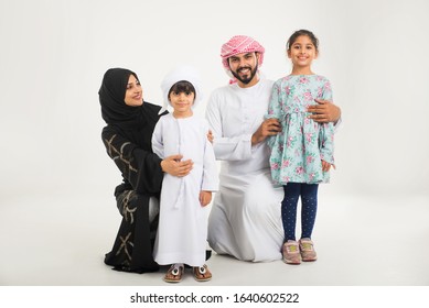 Middle Eastern Family With Traditional Emirates Dresses Posing In A Photographic Studio - Concepts About Lifestyle, Happiness And Family Relationship In The UAE