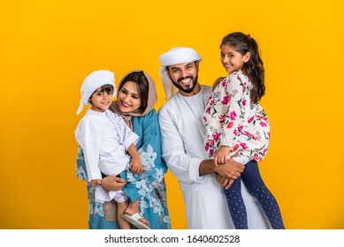 Middle Eastern Family With Traditional Emirates Dresses Posing In A Photographic Studio - Concepts About Lifestyle, Happiness And Family Relationship In The UAE