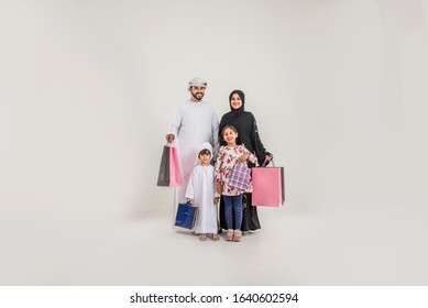 Middle Eastern Family With Traditional Emirates Dresses Posing In A Photographic Studio - Concepts About Lifestyle, Happiness And Family Relationship In The UAE