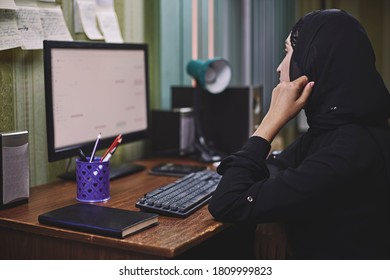 Middle eastern female entrepreneur. Busy Arabian businesswoman. A middle-aged woman in traditional Arabian clothing hijab or abaya working on PC - Shutterstock ID 1809999823