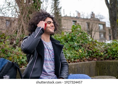 A Middle Eastern man making a fun phone call outdoors
