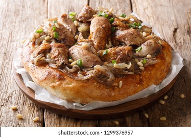 Middle Eastern Meal Of Chicken With Sumac, Pine Nuts And Onions On A Flat Bread Closeup On The Table. Horizontal
