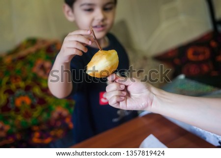 Middle eastern mother giving her kid boy sweet cookies. Muslim cookies. Sharing hot sweet cookies.