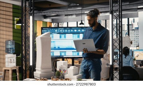 Middle eastern property contractor evaluate a housing construction with architectural software and 3D models to respect zoning regulations and layout rules. Urban development master plan.