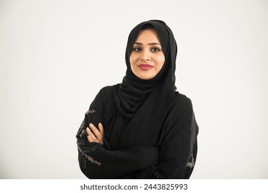 Middle eastern woman with traditional emirates dresses posing in a photographic studio - Concepts about lifestyle, happiness and family relationship in the UAE - Powered by Shutterstock