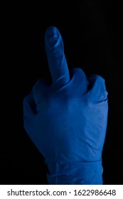 Middle Finger Foam Hand. Hand In Blue Medical Glove . Gesture Means A Rough Form Of The Phrase.