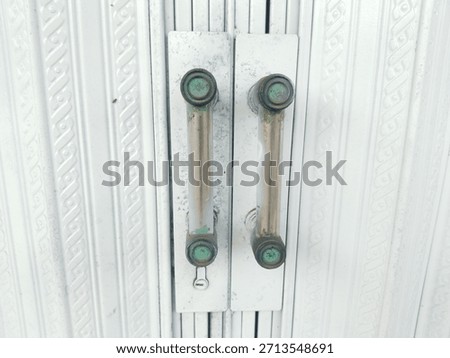 The middle of the harmonica folding gate door is white or pale silver