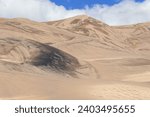 In the middle of high sand dunes in  the Great Sand Dunes National Park in the vicinity of Medano Creek