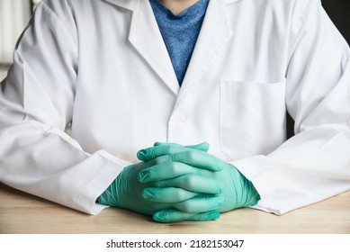 Middle Part Of Doctor Sitting And Put Green Glove