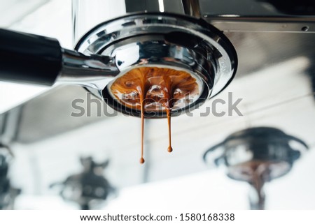 the middle of the process of extracting espresso from a bottomless portafilter