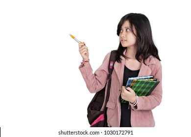 Middle School Girl Pointing Something With A Pen Sideways, Presentation Gesture, Isolated Over White Copy Space