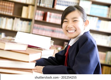 A Middle School Girl Studying In A Library