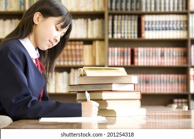 A Middle School Girl Studying In A Library