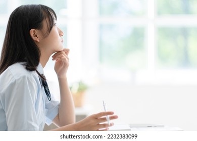 middle school student studying at home - Shutterstock ID 2232383099