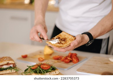 Middle selection of man spread cream cheese on baguette. Home made sandwich - Powered by Shutterstock