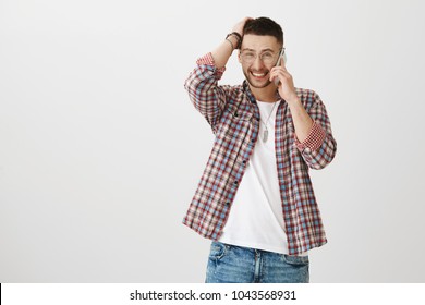 I Am In Middle Of Something So Can Not Talk Sorry. Portrait Of Nice Attractive Man Feeling Awkward While Talking On Smartphone With Girlfriend, Trying To Say He Can Not Make It To Dinner Today