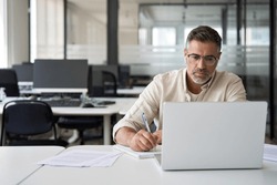 Middle-age Hispanic Man Using Laptop Computer For Business Studying, Watch Online Virtual Webinar Training Meeting, Video Call. Focused Mature Indian Or Latin Businessman Work In Office, Copy Space.