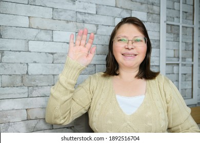 Middle-aged Adult Woman With Glasses Communicates From Home Via Video Link, Gestures With Her Hands, Concept Of Remote Education, Video Conferencing, Lockdown Covid-19