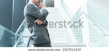 Middle-aged Asian businessman thinking in office