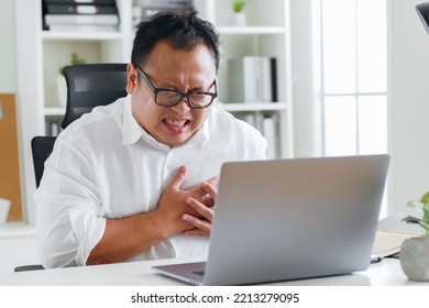 Middle-aged Asian Man Clutch His Chest Because Heart Attack Symptom During Working 