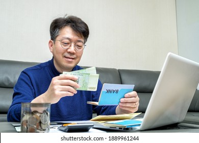 Middle-aged Asian man preparing for tax return. - Shutterstock ID 1889961244
