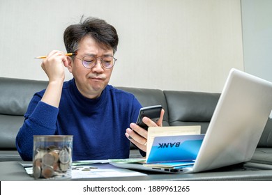 Middle-aged Asian man preparing for tax return. - Shutterstock ID 1889961265