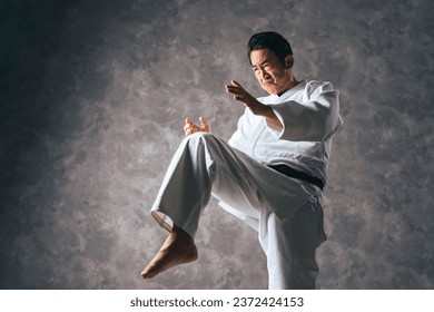 A middle-aged Asian martial artist wearing martial arts uniform. Judoka. Karateka. - Powered by Shutterstock