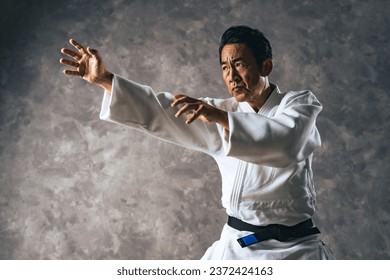 A middle-aged Asian martial artist wearing martial arts uniform. Judoka. Karateka. - Powered by Shutterstock