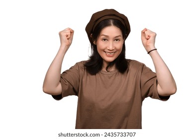 A middle-aged Asian woman celebrating - Powered by Shutterstock