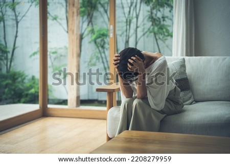 Middle-aged Asian woman in distress