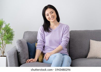 Middle-aged Asian woman in the living room - Shutterstock ID 1943480296