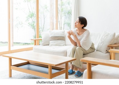 Middle-aged Asian woman relaxing at home - Powered by Shutterstock