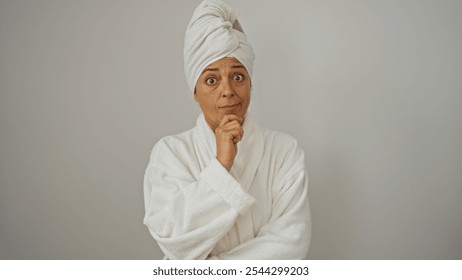 Middle-aged beautiful hispanic woman in a white robe isolated over a white background. - Powered by Shutterstock