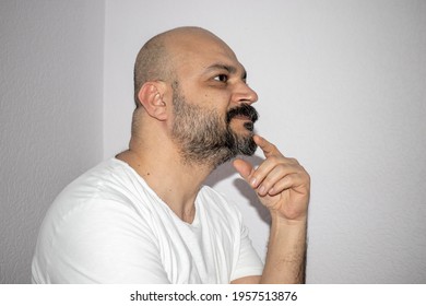 Middle-aged Brunette Male With Beard And Mustache. Thinking Man Trying To Decide