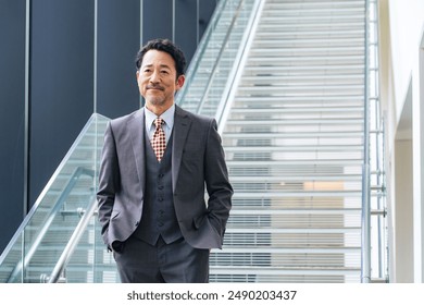 Middle-aged businessman descending the stairs - Powered by Shutterstock