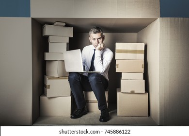 middle-aged businessman in small office working on laptop - Shutterstock ID 745886122