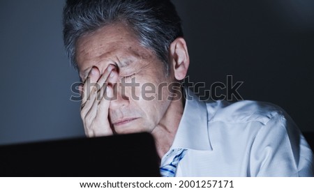 Middle-aged businessman working at night