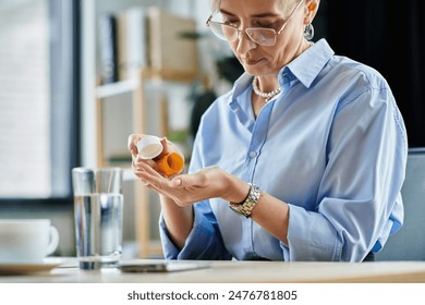 Middle-aged businesswoman with short hair taking pill during menopause - Powered by Shutterstock