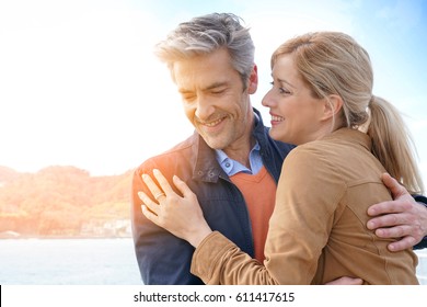 Middle-aged couple embracing each other by the sea, San Sebastian - Powered by Shutterstock